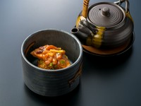 当店自慢の創作茶漬け。炭火で焼いた唐辛子味噌おにぎりに、三陸の銀鮭、気仙沼の塩辛を添えました。個性豊かな地元の幸が、ピリ辛の特製出汁の中で見事に調和します。これぞ仙台彩旬が贈る、〆の最高傑作です。