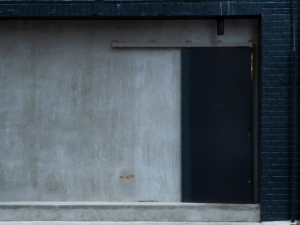 看板がなく、ひっそりとした外観。黒い扉が目印。