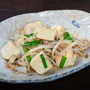 糸満市の名産「宇那志（うなし）豆腐」を使った沖縄名物のチャンプルー。濃厚な島豆腐のような味わいがリピーターから人気です。