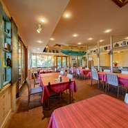 ハワイをイメージした、南国の風を感じる空間。大きな窓から自然の光と風が差し込むオープンな印象となっています。サーフィンの名所が近いこともあり、店内にはボードなどのアイテムも。