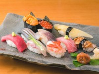 お好み・おきまり・おまかせコースが揃い、その日の気分やシーンに応じて鮨を満喫できるのが【すし屋さい藤】流。気軽＆お得に楽しみたいときは、旬の握り12貫＋お椀のおきまりがオススメです。写真のネタは一例。