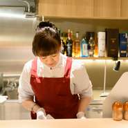 オープンキッチンに立ち、ゲストの顔を見ながら調理する猪狩さん。食事や飲み物の量や好みに目を配り、それぞれのゲストに合った「ちょうどいい」を見極めることを大切にされています。