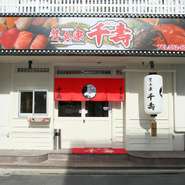 黒川駅の近くに構える【贅食家　千壽】は、清潔感のある白を基調にした外観に赤いのれんが印象的。鮮度抜群の海の幸や手間暇かけた料理のほか、お酒の品ぞろえも充実しており、幅広い世代に支持されています。