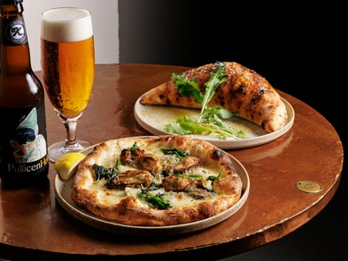 牡蠣の旨みとチーズのコク。一番人気のピッツア『牡蠣のピッツア』