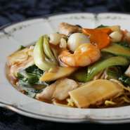 煎り焼きしてパリパリの食感に仕上げたそばの上に、海老などの具がたくさん入った餡をかけています。餡が染み込んで柔らかくなったところ、パリッと感が残っているところ、さまざまな食感を楽しめる一品です。