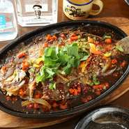 中国料理の本場で修業した料理人がつくる鉄板料理は店の看板メニューです。その中でも旬の鮮魚を鉄板焼きにした『鉄板魚』は、人気と実力を兼ね備えた一品です。