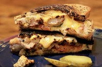 話題のニューヨーク生まれのホットサンド。バターでこんがり焼いたパンに、たっぷりレッドチェダー、モッツアレラ、ミックスチーズを挟んで半分カット。こぼれ落ちる断面チーズはチーズ好きにはたまりません。