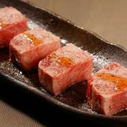 店の人気メニュー。肉汁を逃さない絶妙なカットで、一口ごとに広がるジューシーさと程よい脂の旨みが特徴です。特製の調味塩と香り豊かな胡麻油が、そのおいしさをさらに引き立てています。
