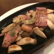 ベーコンの旨味をまとったプリプリえりんぎ
を熱々の鉄板で提供。