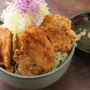 秘伝のタレに一晩漬け込んだ地養鳥の唐揚げを、ご飯と山盛りのキャベツ、炒めた豚肉の上に乗せた食べ応えのある逸品。セットのわかめスープは和牛カルビで出汁を取ってあり、旨みたっぷりです。