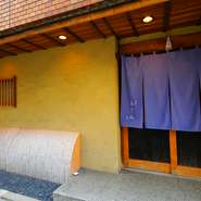 【銀座　あさみ】は、大通りから1本路地を入った裏通りにひっそりと佇む、隠れ家的なお店です。藍色の大きな暖簾が唯一の目印。常に店内は満席であることから、その人気ぶりが伺えます。