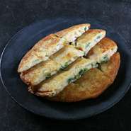 京野菜の九条ネギがたっぷり。ネギの旨みを存分に味わえます。表面サクッ、中はふわモチの食感も魅力です。