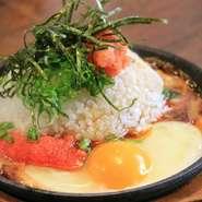 人気商品！　熱々の鉄板に玉子をグツグツさせ、ご飯の上に明太子、タレをバァッとかけてますので、グチャグチャに混ぜて召し上がれ。