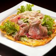 クリスピーな薄手の生地が特徴のピッツァ。生ハムと野菜が贅沢に載っているのでサラダ感覚でどうぞ。