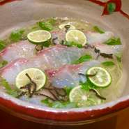 鯛の出汁と鶏がらの澄んだ旨みのあるスープに鯛の昆布締め刺しとすだちを並べた温そうめん
