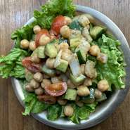 ひよこ豆にトマト、キュウリ、タマネギを加え、クミンやマサラといったスパイスとともに和えた一品。