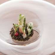 ライ麦パンやアボカドでつくられた“大地”の上に、“雪化粧”した春野菜のフリッターが顔を出します。