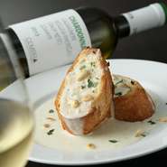 ゴルゴンゾーラチーズを生クリームでのばし、バゲットのガーリックトーストにかけたワインと好相性の一品。