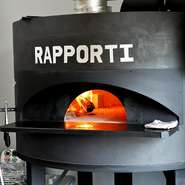 存在感のある大きな薪窯は職人さんの手づくり。450度の高温で、1分で焼き上げるナポリピッツァは外はカリカリ、中はもっちりとした食感に仕上がります。生地は小麦粉と水・酵母・塩だけで仕込み、手延ばしされます。