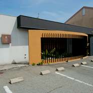 駐車スペースの奥には、懐石の由来となった風雅な「茶」の世界が。座敷からは昼は陽の光が、夜は月明かりを楽しめるよう、大きな窓を配置。また店内はどの部屋も茶室風につくられ、落ち着いた和空間になっています。