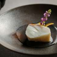 身の厚いクエは、表面が乾かないよう気を配りながら、何度もオーブンから出し入れしてゆっくりゆっくり蒸しながら火を入れ、最後に皮目をパリッと焼いて食感のバランスを整えています。