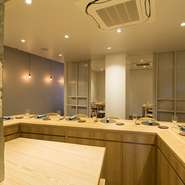 向かいの席の方と真正面にならない様、少し広がりのあるコの字型のカウンター席。木の質感が心地よいでテーブルで、ゆっくりと料理とワインをいただけば、二人の距離もぐっと身近に。