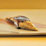 長崎や広島産の最高級の穴子を使用。長年継ぎたされた出汁で丁寧にふっくらと炊き上げ、とろける食感に。香ばしく炙ったあと、秘伝の甘辛ダレをさっと塗ります。