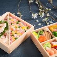 四つに仕切られた一の段は「お持ち帰りできる懐石料理」。春が旬の蛤はピカタにし、貝の旨味を卵で閉じました。​二の段は春らしい「鯛と桜の香り御飯」と「蟹とビーツのちらし寿司」。繊細な料理をご堪能ください。