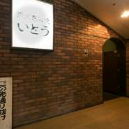 ビルの長い廊下を進んだ先に、ひっそりと佇む【炭火あみ焼　いとう】。栄駅から徒歩5分という賑やかな立地にありながら、都会の喧騒を感じさせない隠れ家のような落ち着いた雰囲気が魅力です。