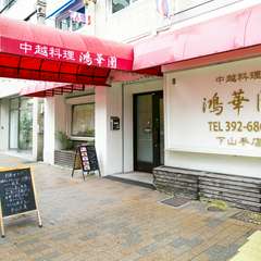 白い壁に赤いシェードが映える、モダンな外観