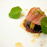 フランス産上質肉を主役に据え、中華アレンジを加えた一皿。和出汁ベースの麻婆ソースの上に、揚げ茄子、香ばしく炭火焼した仔鴨を重ね、メネギとナスタチュームでアクセントを。仏・中・和が調和した新感覚の美味。