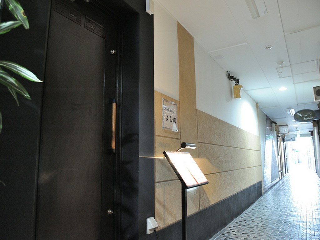 ビル入口から通路を通った先。上質な空間へと続く重厚な扉