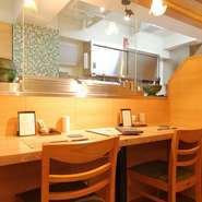 木目と緑を基調としたインテリアで落ち着いた大人の雰囲気の店内。一つ一つの席のスペースは広くゆったりで、ホッとひと息つける居心地のよい空間です。普段使いデートから、ゆっくりとしたお食事まで使えます。