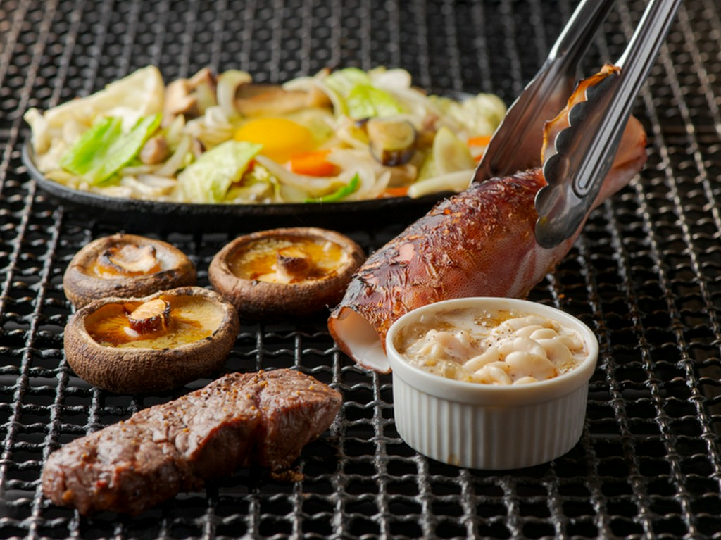 オープンキッチンで調理される、昔ながらの炉端焼きの店