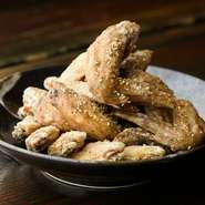 常連からの熱い人気を集める手羽先。並盛（5本）からオーダー可能。コクのタレとスパイシーなコショウ、2つのフレーバーを用意、ハーフ＆ハーフもできます。テイクアウトもできるのでお土産にもぴったりです。
