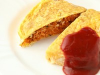 富山の新ブランド米「富富富」を使用。トマトソースとケチャップを合わせた自家製ソースを鉄板の上で混ぜ合わせ、特製のケチャップライスを卵白をメレンゲ状にしたふわふわ卵で包み込んで仕上げます。
