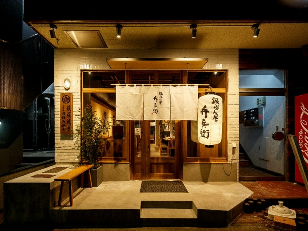 白い暖簾と提灯が目印の和モダンな外観