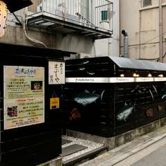 一目で魚を扱う店と認識できる、マグロやヒラメが描かれた黒壁