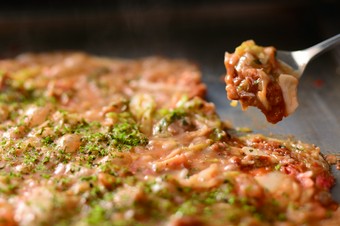 出汁や具材の風味とおこげの香ばしさが口いっぱいに広がる、熱々の『もんじゃ』