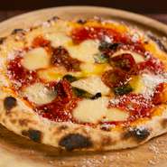 国産小麦を使った手ごねのピザ生地に、北海道のモッツアレラチーズをセレクト。古閑氏がナポリ修業時代に学んだレシピをアレンジしたオリジナルの『マルゲリータ』は噛み応え十分のあとを引くおいしさです。