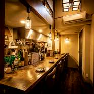 気軽に立ち寄れる雰囲気の店内。カウンター席があるので、ひとりでもゆったりと食事と酒が味わえます。料理人が目の前で調理の腕をふるう姿を眺めながら、くつろぎのひと時を。