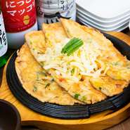 ネギもニラも入っていてチーズたっぷりの海鮮チヂミです。とくに女性に人気で、ボリュームあるメニューです。