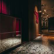 世界の時計ブランドが居並ぶ並木通りにインスピレーションを得て、時計の部品で牛を表現したオブジェ。赤と黒をベースにしたスタイリッシュな店内など、細部に至るまでワンランク上の雰囲気を醸し出しています。