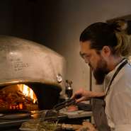 ガス火を使わず、すべて薪火による窯で調理。ケルン窯では肉の調理や燻製を。ピザ窯は野菜を焼き上げます。高温の窯を使うことで、中は瑞々しく、外は香ばしく仕上がり野菜のうまみが存分に引き出されます。