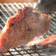 『穀物ラムのステーキジンギスカン』はコースに追加できる特選メニューの逸品。新鮮なラム肉170gはしっかり味付けされ、目の前の炭火いろりで豪快に焼き上げる人気メニューです。