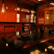 店内はフィラメントの灯りが揺れ、非日常的な感覚に浸ることができます。漆黒のテーブルの中央には、美しい波紋を立てながら水が流れ、印象的な夜になることを予感させます。