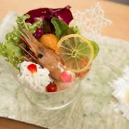 信楽焼の器に据えられているのは1960年代もののバカラ「シャンパンクープ」。その中へ旬魚・旬菜がブーケをイメージし丁寧にセッティングされています。季節のドレッシングはアンティークのフラスコで。