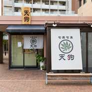 清潔感のある白暖簾と趣のある木の看板が目を引く【天狗】。店内に足を踏み入れると、ほっと心が落ち着く居心地のよい空間が広がります。友人の家を訪れるような感覚で、毎日でも足を運びたくなります。