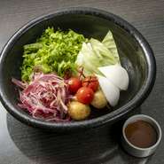 ゲストにその日並ぶ野菜の産地と生産者を示した、人気のサラダ。みずみずしい野菜を引き立てるオリジナルのバーニャドレッシングが評判です。