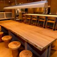 店内の中央に広がる12名掛けの大テーブルは、熊本県産の大きな一枚板でつくられています。丸太のようなかわいらしい椅子も、もちろん熊本県産の木材。料理だけでなく、インテリアにもこだわりが感じられます。